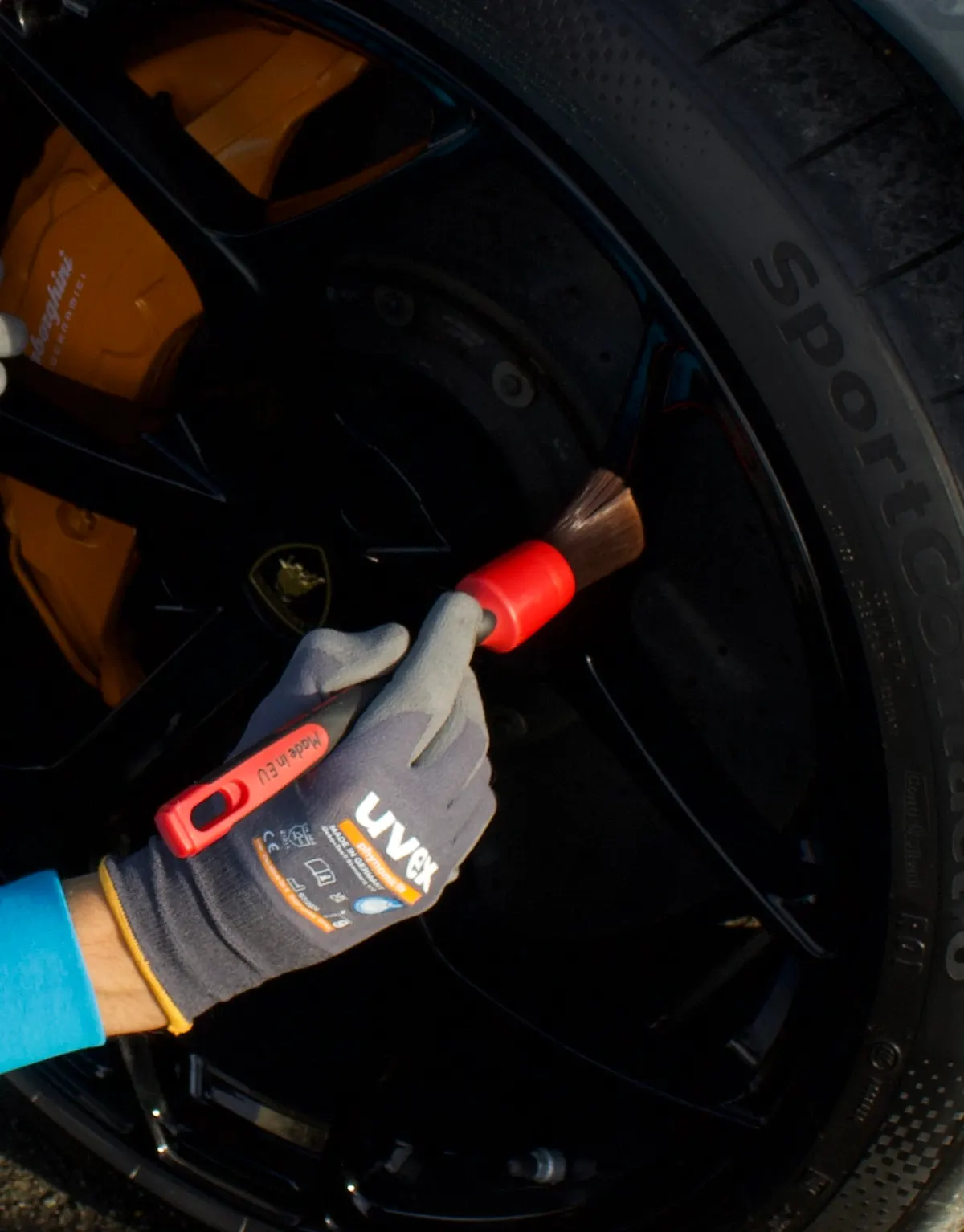 Detail brush in use cleaning a Lamborghini wheel